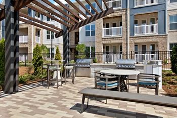 Shaded outdoor pavilion w/ grilling stations, tv's, fire pit, & putting green