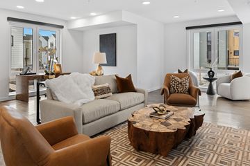 Bozeman townhouse for rent - A living room with a brown leather chair and a wooden coffee table.
