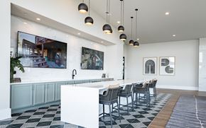 Atlanta apartment for rent - a communal table and chairs in a large room with white walls and a white counter