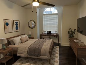 Atlanta apartment for rent - A bedroom with a bed, nightstand, and a ceiling fan.