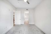 Decatur apartment for rent - A spacious room with a ceiling fan and carpeted floor.