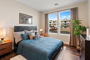 Bozeman apartment for rent - a bedroom with a bed and a window with a city view
