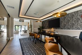 Coconut Creek apartment for rent - A modern dining area with a black and white patterned wallpaper.