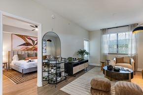 Coconut Creek apartment for rent - A bedroom with a large bed and a mirror on the wall.
