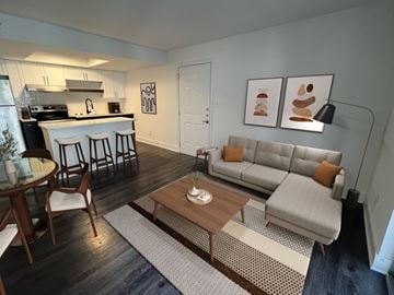 Atlanta apartment for rent - A modern living room with a grey couch and a wooden coffee table.