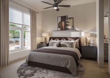 Kennesaw apartment for rent - A bedroom with a large bed and a ceiling fan.