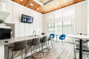 Oak Ridge apartment for rent - A modern kitchen with a bar area and a television mounted on the wall.