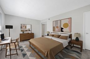 East Point apartment for rent - a bedroom with a bed and a desk with a chair