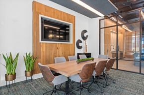 Huntsville apartment for rent - A conference room with a wooden table and chairs.