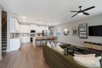 Mcdonough apartment for rent - A living room with a couch and a dining table.