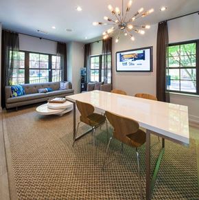 Brookhaven apartment for rent - A modern dining room with a white table and chairs.