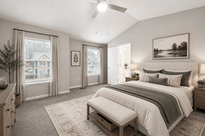 Loganville apartment for rent - A bedroom with a large bed and a window with curtains.