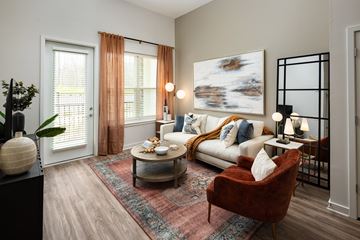 Cumming apartment for rent - A living room with a red chair and a white couch.