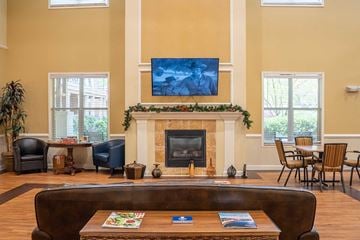 Pensacola apartment for rent - A living room with a fireplace and a painting on the wall.