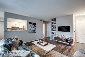 Manassas apartment for rent - A living room with a blue couch and a white coffee table.
