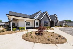 Lenoir City apartment for rent - A modern house with a white front door and a landscaped front yard.