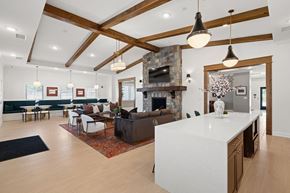 Lenoir City apartment for rent - A modern living room with a stone fireplace and a kitchen area.
