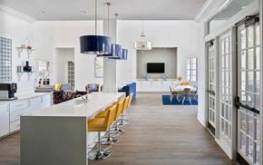 Tampa apartment for rent - a kitchen with a long white counter and yellow chairs