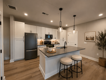 Gallatin apartment for rent - A kitchen with a black refrigerator and white cabinets.