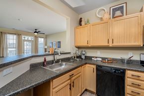 Cold Spring apartment for rent - A kitchen with wooden cabinets and a black dishwasher.