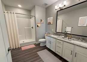 Athens apartment for rent - A bathroom with a toilet, sink, and shower.