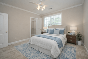 Columbus apartment for rent - A bedroom with a large bed and a ceiling fan.