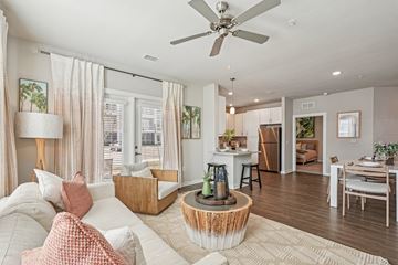 Bradenton apartment for rent - A living room with a white couch and a wooden coffee table.