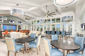 Bradenton apartment for rent - A modern dining room with a large table surrounded by chairs.
