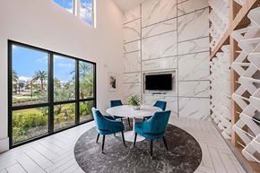 Sarasota apartment for rent - A modern dining room with a round table and chairs.
