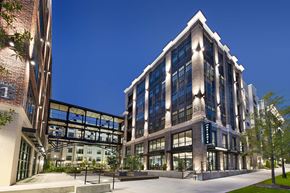 Chamblee apartment for rent - A modern building with a glass facade and a brick exterior.