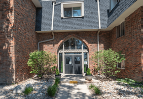 Colorado Springs apartment for rent - A brick building with a large arched entrance and a small window above it.