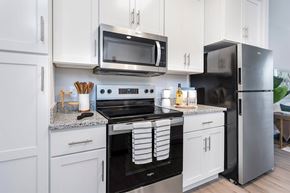 Wyoming apartment for rent - A modern kitchen with white cabinets and stainless steel appliances.