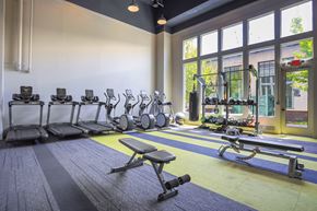 Fayetteville apartment for rent - A gym with a variety of equipment including treadmills, weights, and exercise balls.