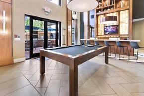 Atlanta apartment for rent - A pool table in a room with a television and a bar.