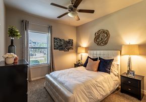 San Antonio apartment for rent - a bedroom with a large bed and a ceiling fan
