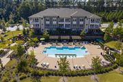 Greenville apartment for rent - an aerial view of an outdoor pool with a building in the background