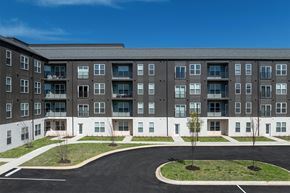 Rogers apartment for rent - an apartment building with a roundabout in front of it