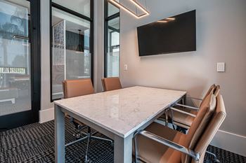 A conference room with a marble table and chairs