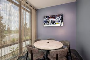 Apollo Beach apartment for rent - a dining room with a table and chairs and a tv on the wall