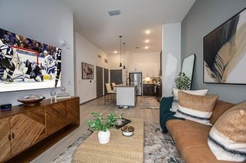 Wood plank flooring in kitchen, living and dining areas