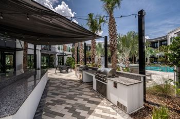 Courtyard w/ outdoor kitchen, firepit, and entertaining areas