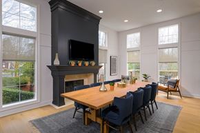 Alpharetta apartment for rent - a dining room with a wooden table and chairs in front of a fireplace