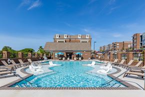 Cane Ridge apartment for rent - A large swimming pool with a building in the background.
