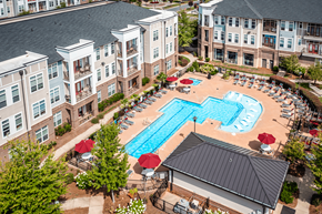 Huntersville apartment for rent - An aerial view of a pool surrounded by chairs and umbrellas.