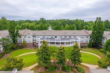 Kennesaw apartment for rent - A large white building with a green lawn in front.