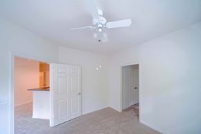 Kennesaw apartment for rent - A room with a ceiling fan and two doors.