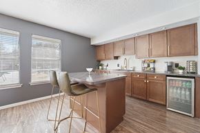 Odessa apartment for rent - A kitchen with a table and chairs in front of a refrigerator.