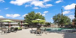 Odessa apartment for rent - A pool area with sun loungers and umbrellas.