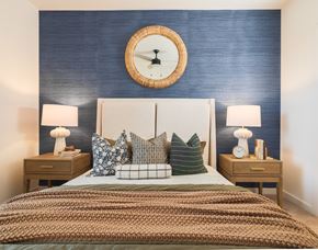 Richmond Hill apartment for rent - A bedroom with a bed, two nightstands, and a round mirror on the wall.