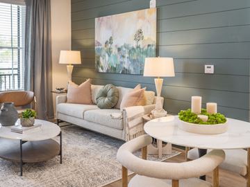 Pooler apartment for rent - A living room with a white couch, a round table, and a painting on the wall.